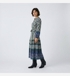 Three-quarter view of a cream, blue, green long-sleeve midi dress with geometric floral patterns, tie-waist, tiered skirt.