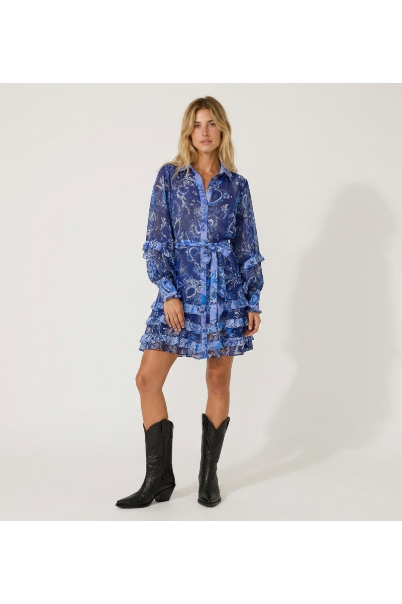 Front view of a sheer blue and white floral mini dress with long ruffled sleeves, collar, and tiered skirt.