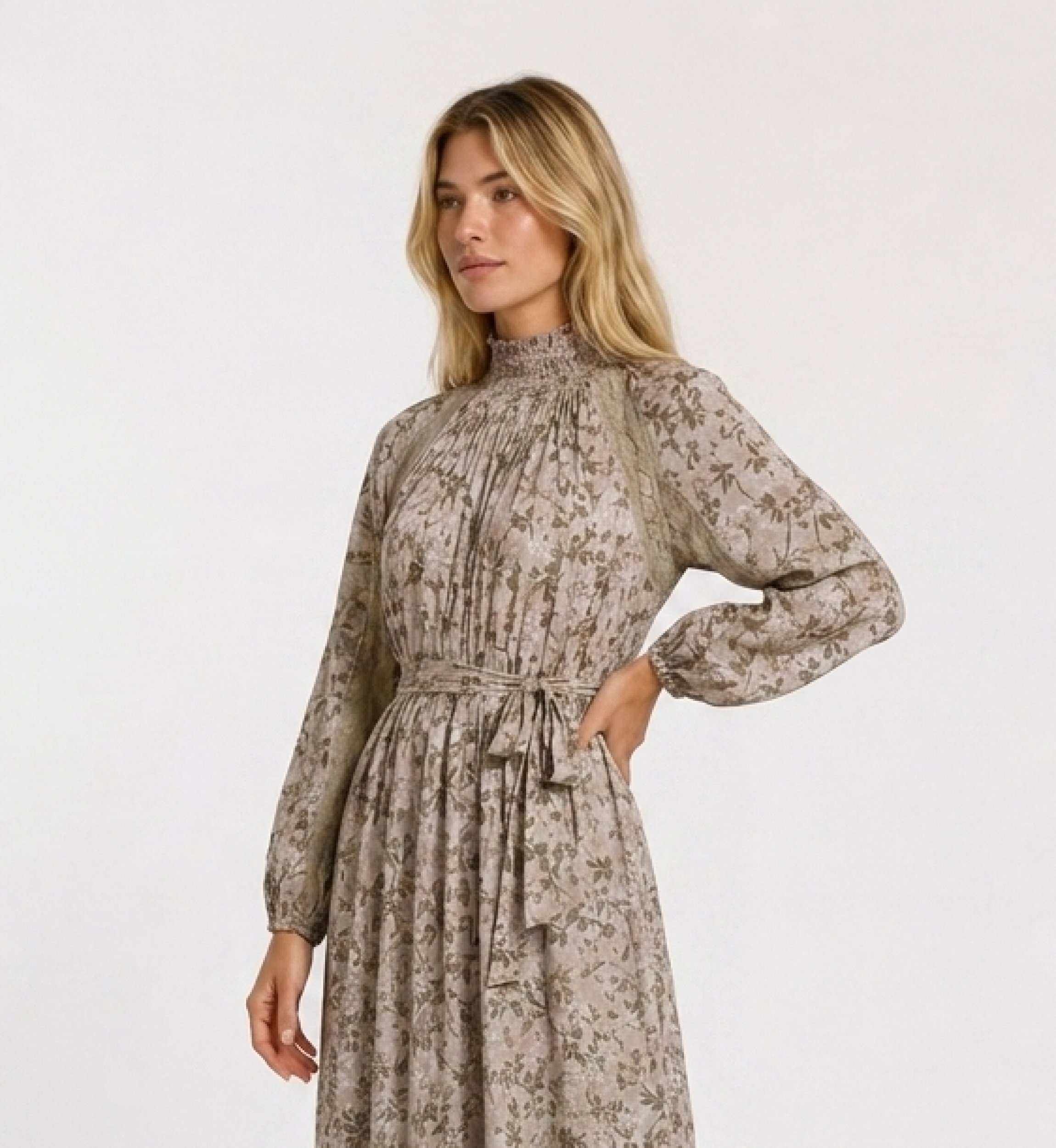 Light pink floral maxi dress, green gold leaf pattern. High smocked neck, long puff sleeves, lace trim. Three-quarter side view.