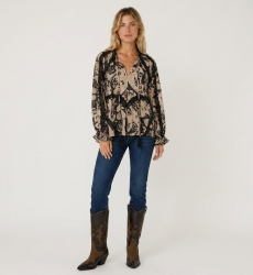 Blouse ample à manches longues motif beige et noir, détails volants et pompons, tissu léger, vue de face.