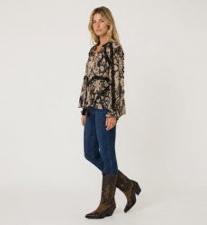 Blouse ample à manches longues beige et noire imprimée, avec volants et pompons, tissu léger.