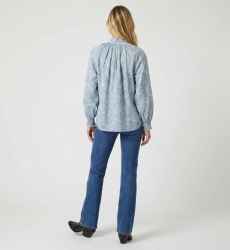 Light blue long-sleeve blouse with white paisley pattern, high collar, ruffled cuffs, back view. Elegant button-down shirt.