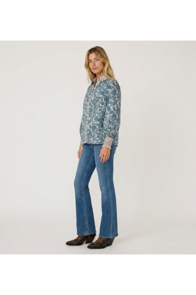Elegant white women's blouse with a relaxed fit, made from lightweight fabric, shown in a three-quarter side view. Perfect for a