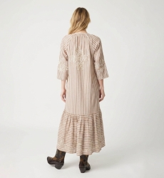 Back view of a brown and white striped midi dress with a tiered skirt, white floral embroidery, tie waist, and tassels.