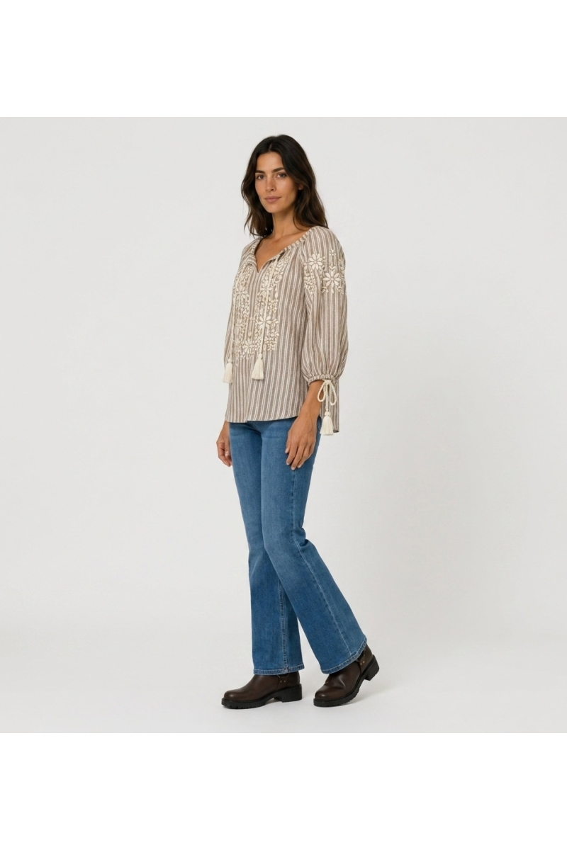 Blouse paysanne rayée marron/blanc, col V, manches ballon 3/4, broderie florale, pompons. Vue de côté.