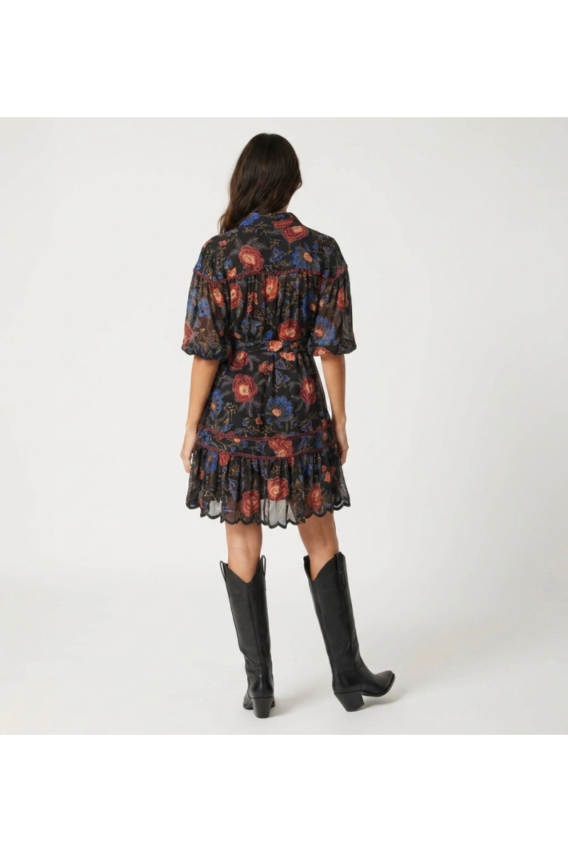 Black collared mini dress with red blue floral pattern, three-quarter balloon sleeves, tie-waist, tiered scalloped hem, back vie