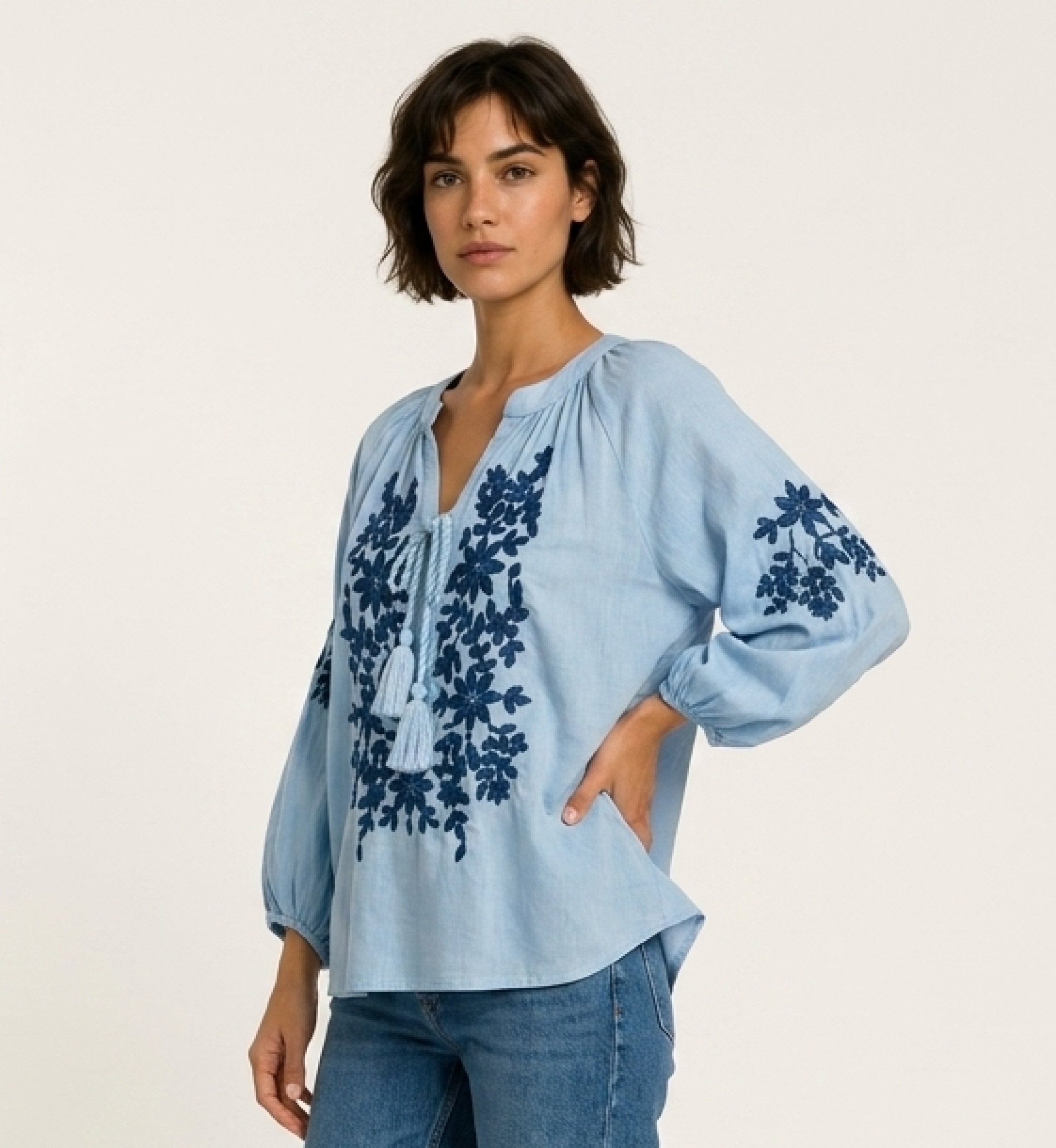 Blouse paysanne noire à manches longues, col V, lien à nouer et broderie florale crème. Tissu aspect lin, vue 3/4.