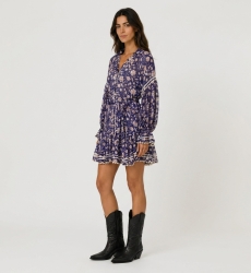 Three-quarter view of a sheer navy floral mini-dress with long balloon sleeves, collared V-neck, tiered skirt, and tie-belt.