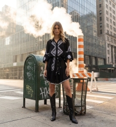 Chic short dress for women, elegant and modern, photographed in an urban city setting with industrial elements.
